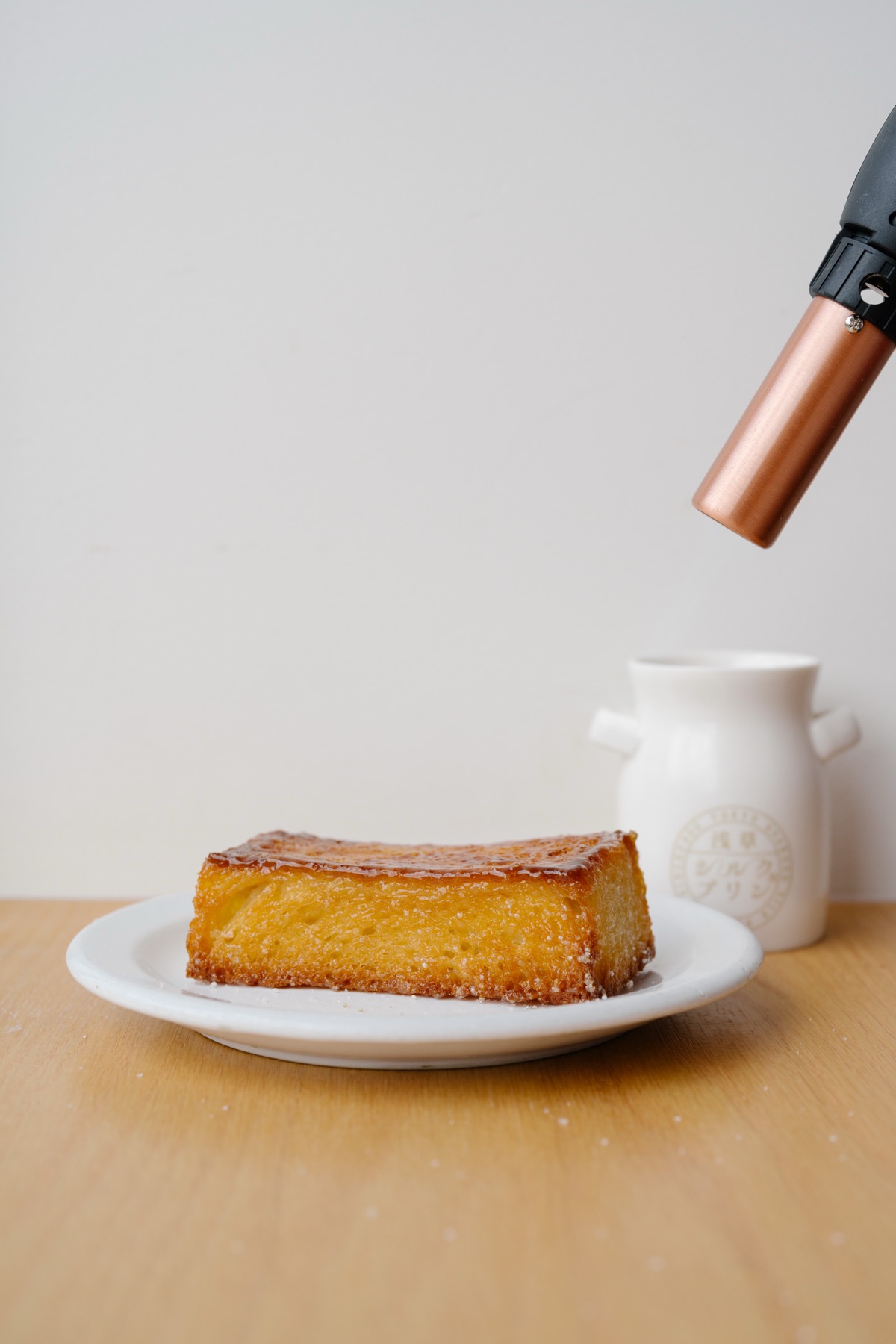 A kitchen torch caramelizing honey toast